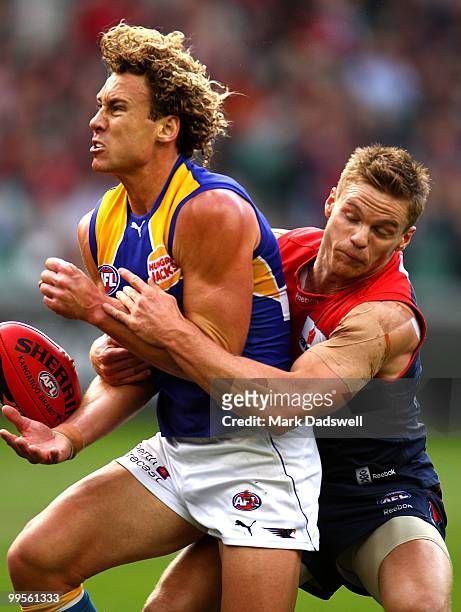 Matt Priddis of the Eagles is tackled by Colin Sylvia of the Demons during the round eight AFL match between the Melbourne Demons and the West Coast...