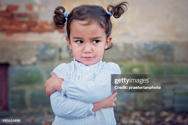 angry little girl - sour faced stock pictures, royalty-free photos & images