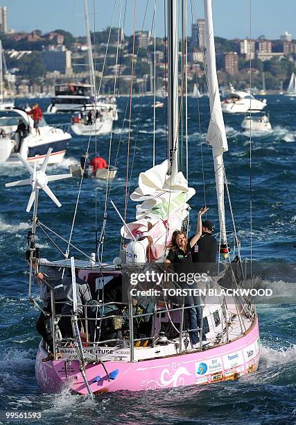 Australian round-the-world sailor, Jessica Watson, waves to a flotilla of well-wishers as her yacht 'Ella's Pink Lady' motors up Sydney Harbour on...