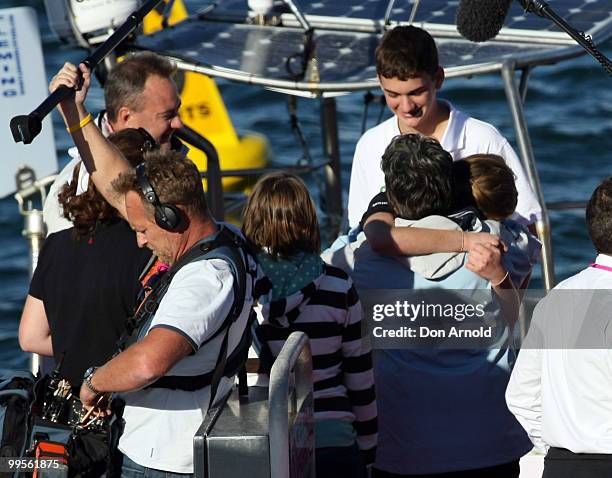 Teen sailor Jessica Watson arrives back home in Sydney and is rewarded with a hug from mother Julie, as father Roger and brother Tom look on...