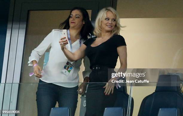 Pamela Anderson, girlfriend of Adil Rami of France celebrates with a friend the victory following the 2018 FIFA World Cup Russia Semi Final match...