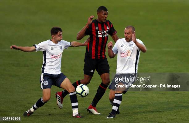 Bury's Stephen Dawson and Chris Sang battle for the ball with Huddersfield Town's Collin Quaner during the pre-season friendly match at the Energy...