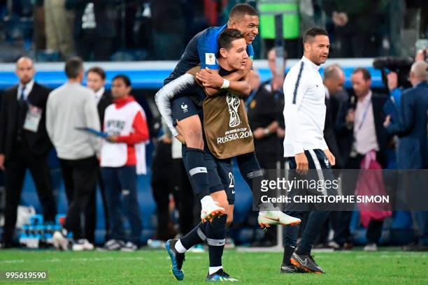 France's forward Kylian Mbappe celebrates with France's forward Florian Thauvin at the end of the Russia 2018 World Cup semi-final football match...
