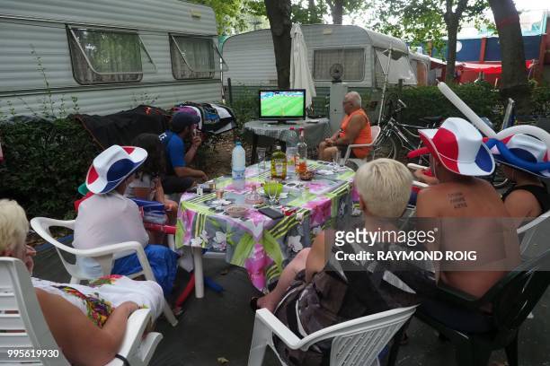 French holidaymakers look at a television set at a camp site in Argeles-sur-Mer on July 10 as they watch the 2018 Russia World Cup semi-final...