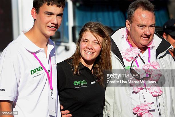 Tom Watson assists sister teen sailor Jessica Watson with father Roger Watson as she arrives back home in Sydney following her world record attempt...