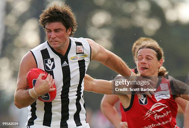 Leigh Brown of Collingwood is tackled by Paul Kennedy of Frankston during the round six VFL match between Collingwood and Frankston at Frankston Oval...