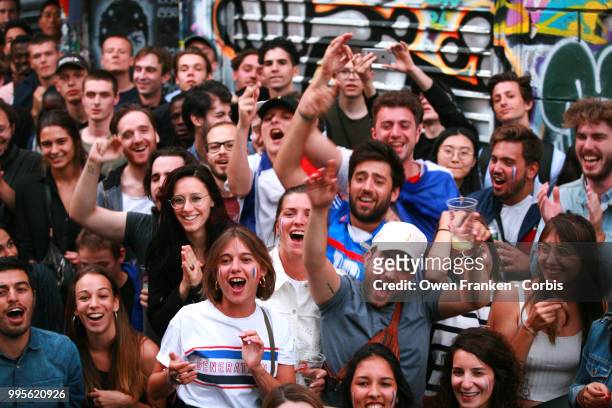 French fans erupt with joy, outside a local bar in the 20th arrondissement, as France wins its semi-final World Cup match against Belgium, on July...