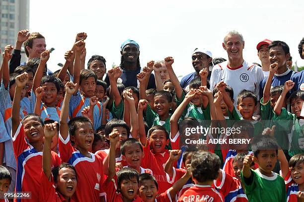 Children waves flags as Liverpool football legend Ian Rush attends a coaching clinic for children in Jakarta on May 15, 2010. Rush took part in a...