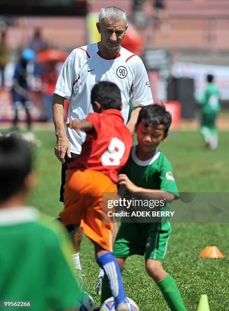 Liverpool football legend Ian Rush attends a children's coaching clinic in Jakarta on May 15, 2010. Rush took part in a series of sports activities...