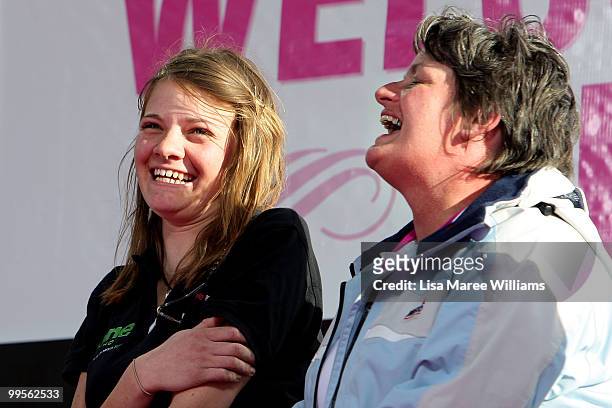 Teen sailor Jessica Watson sits with her mother Julie Watson on stage after arriving home in Sydney following her world record attempt to become the...