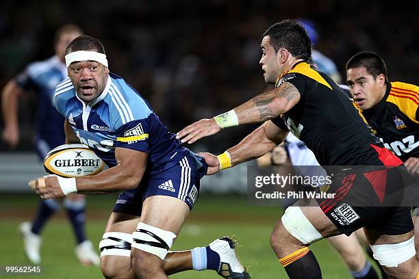 Viliami Ma'afu of the Blues is pulled back by Liaam Messam of the Chiefs during the round 14 Super 14 match between the Blues and the Chiefs at Eden...