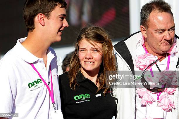 Tom Watson assists sister teen sailor Jessica Watson with father Roger Watson as she arrives back home in Sydney following her world record attempt...