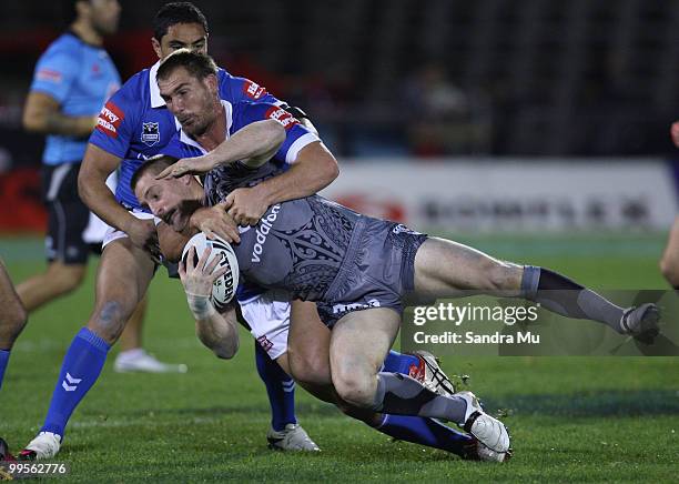 Brent Tate of the Warriors is tackled by Scott Bolton of the Cowboys during the round 10 NRL match between the Warriors and the North Queensland...