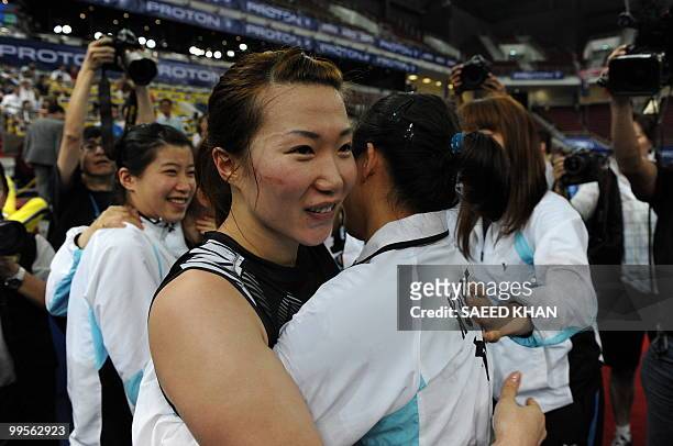 South Korea's Min Jung Kim is congratulated by team members after a victory over China's Ma Jin and Wang Xiaoli in the finals round of the Uber Cup...