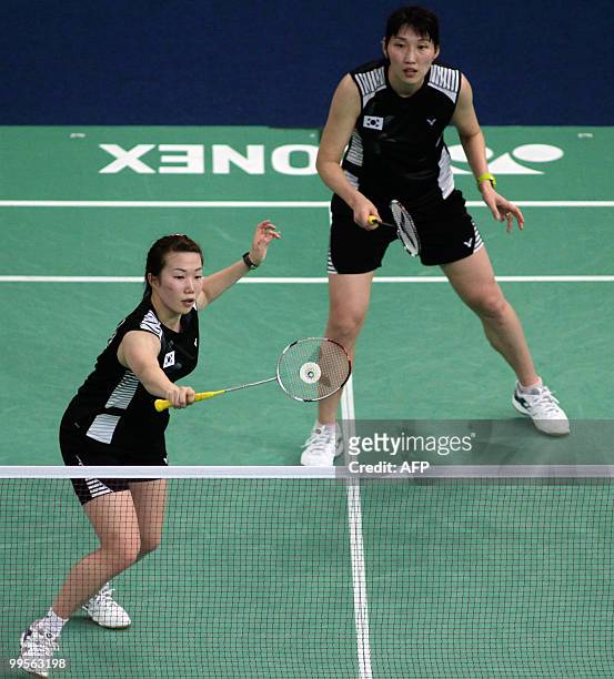 South Korea's Kim Min Jung returns a shot as her teammate Lee Hyo Jung looks on while playing against China's Ma Jin and Wang Xiaoli during the Uber...