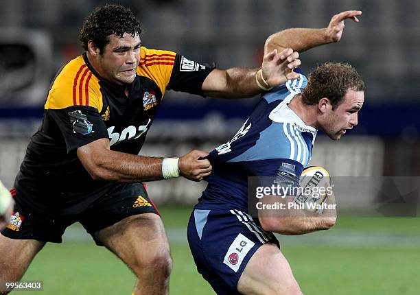 Alby Mathewson of the Blues is tackled by Ben Afeaki of the Chiefs during the round 14 Super 14 match between the Blues and the Chiefs at Eden Park...