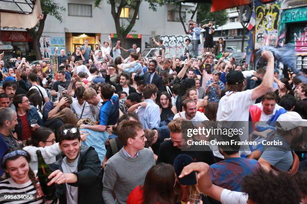 French fans erupt with joy, outside a local bar in the 20th arrondissement, as France wins its semi-final World Cup match against Belgium, on July...
