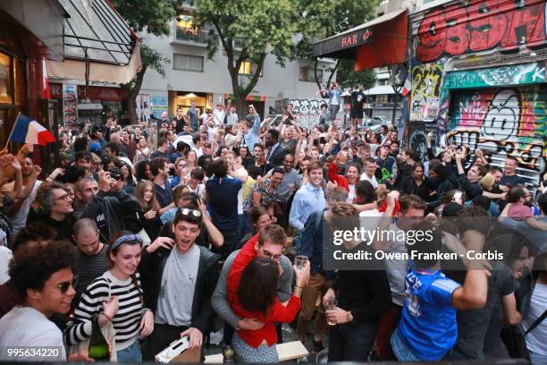 French fans erupt with joy, outside a local bar in the 20th arrondissement, as France wins its semi-final World Cup match against Belgium, on July...