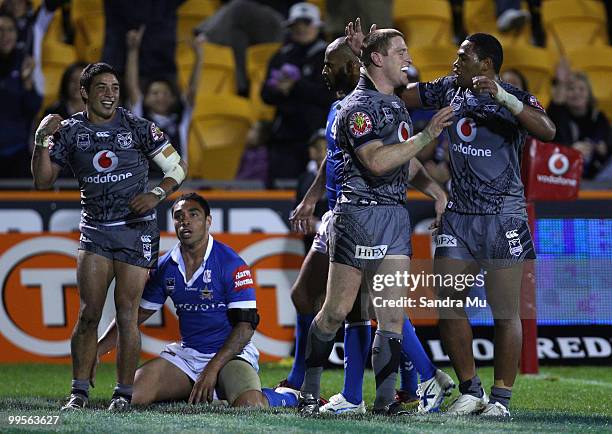 Kevin Locke , Brent Tate and Ukuma Ta'ai of the Warriors celebrate Locke's try during the round 10 NRL match between the Warriors and the North...