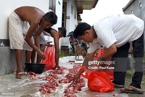 Pig meat is divided up and bagged for families after slaughtering ahead of the Balinese holiday Galungan on May 10, 2010 in Canggu, Indonesia....