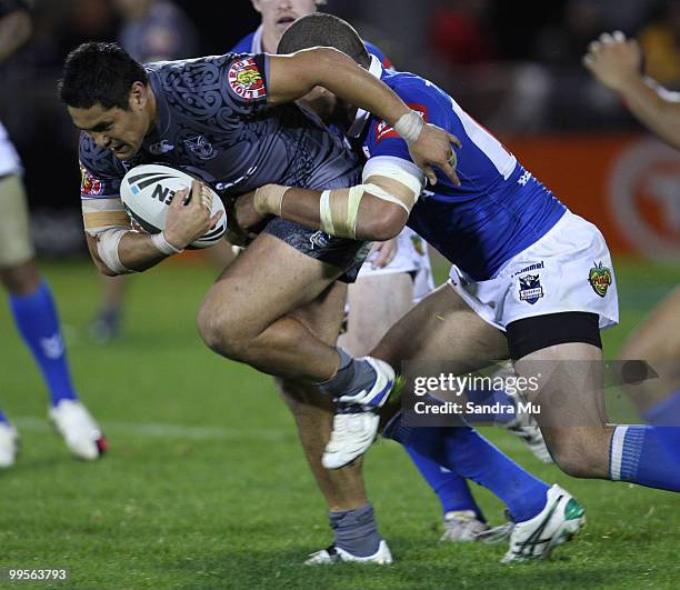 Jerome Ropati of the Warriors is tackled during the round 10 NRL match between the Warriors and the North Queensland Cowboys at Mt Smart Stadium on...