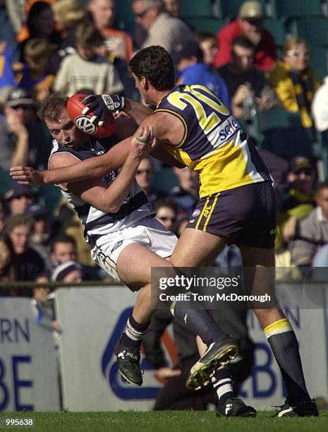 David Mensch for Geelong is tackled by Dean Cox the West Coast Eagles, in the match between the West Coast Eagles and the Geelong Cats, during round...