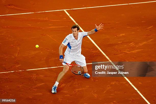 Andy Murray of Great Britain slides to play a backhand to David Ferrer of Spain in their quarter final match during the Mutua Madrilena Madrid Open...