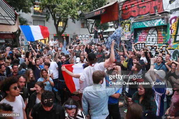 French fans erupt with joy, outside a local bar in the 20th arrondissement, as France wins its semi-final World Cup match against Belgium, on July...