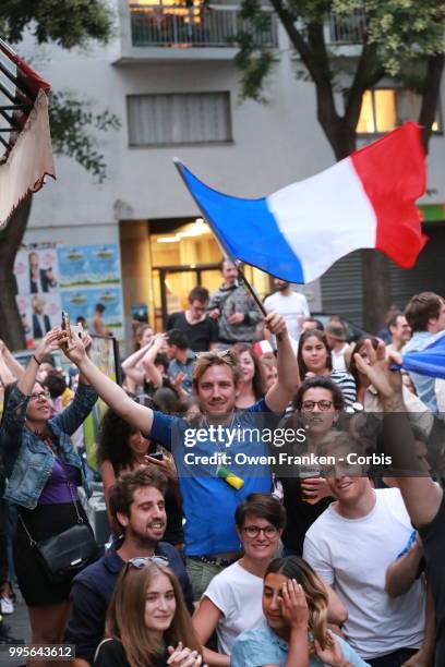 French fans erupt with joy, outside a local bar in the 20th arrondissement, as France wins its semi-final World Cup match against Belgium, on July...