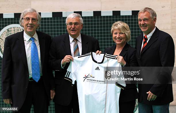 Holger Obermann, Theo Zwanziger, president of the German Football Federation, Cornelia Pieper, minister of state and Rainer Zobel pose for a photo at...