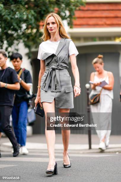 Lauren Santo Domingo wears a gray dress, a white t-shirt, a knot, black shoes , outside Givenchy, during Paris Fashion Week Haute Couture Fall Winter...