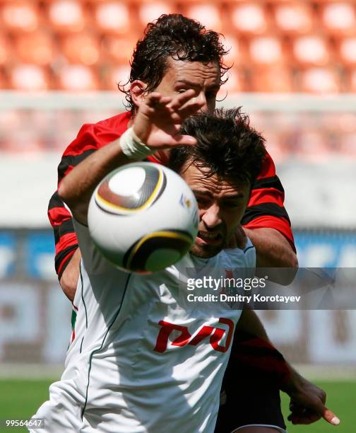 Marko Basa of FC Lokomotiv Moscow battles for the ball with Vito of FC Amkar Perm during the Russian Football League Championship match between FC...