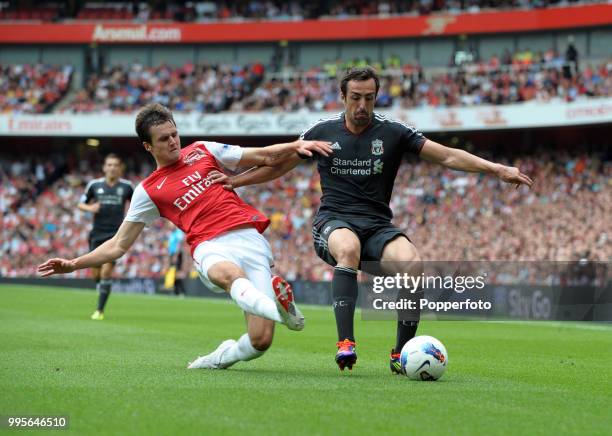 Carl Jenkinson of Arsenal and Jose Enrique of Liverpool in action during the Barclays Premier League match between Arsenal and Liverpool at the...