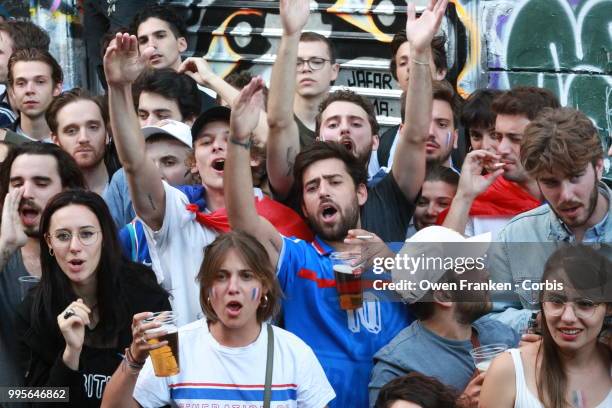 Crowd watches the France v Belgium semi-final World Cup match outside a local bar in the 20th arrondissement, on July 10, 2018 in Paris, France.