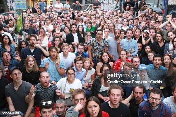 Crowd watches the France-Belgium semi-finale World Cup match outside a local bar in the 20th arrondissement, on July 10, 2018 in Paris, France.