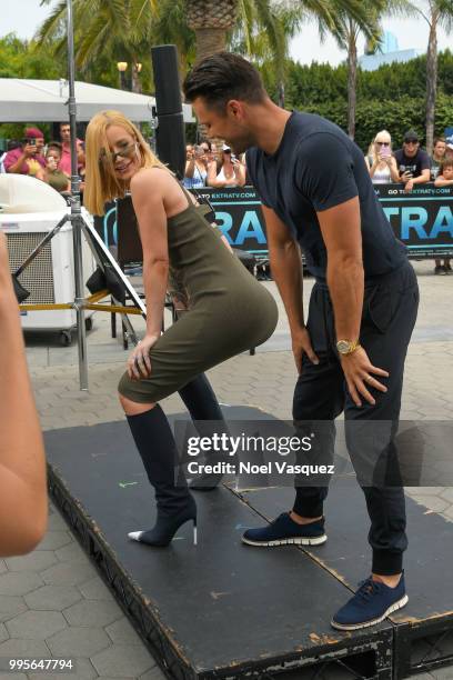 Iggy Azalea teaches Mark Wright how to twerk at "Extra" at Universal Studios Hollywood on July 10, 2018 in Universal City, California.