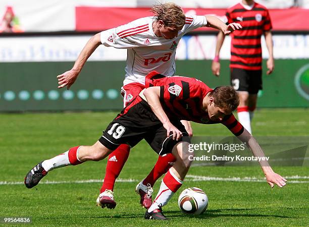 Dmitri Tarasov of FC Lokomotiv Moscow battles for the ball with Aleksandr Kolomeytsev of FC Amkar Perm during the Russian Football League...