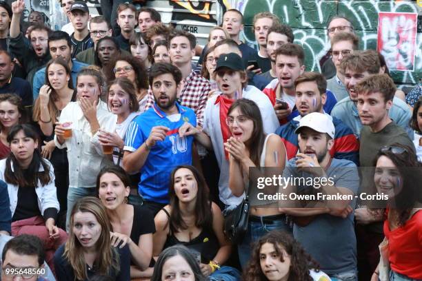 Crowd watches the France v Belgium semi-final World Cup match outside a local bar in the 20th arrondissement, on July 10, 2018 in Paris, France.
