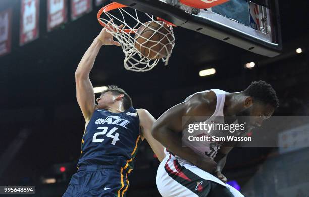 Grayson Allen of the Utah Jazz dunks against Ike Nwamu of the Miami Heat during the 2018 NBA Summer League at the Thomas & Mack Center on July 10,...