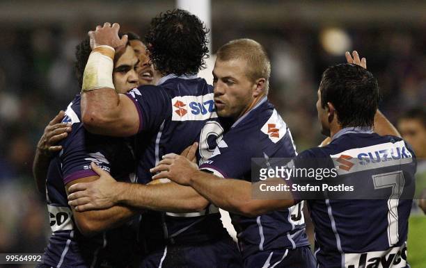 Storm players celebrate after Greg Inglis scored a try during the round ten NRL match between the Canberra Raiders and the Melbourne Storm at...