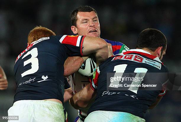 Steve Simpson of the Knights is tackled during the round ten NRL match between the Sydney Roosters and the Newcastle Knights at Bluetongue Stadium on...