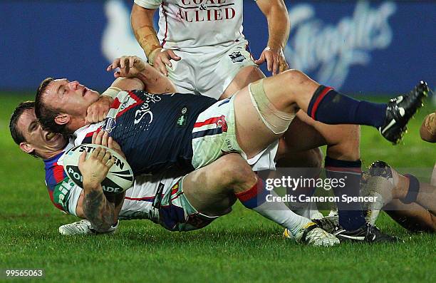 Jake Friend of the Roosters is tackled by Kurt Gidley of the Knights during the round ten NRL match between the Sydney Roosters and the Newcastle...