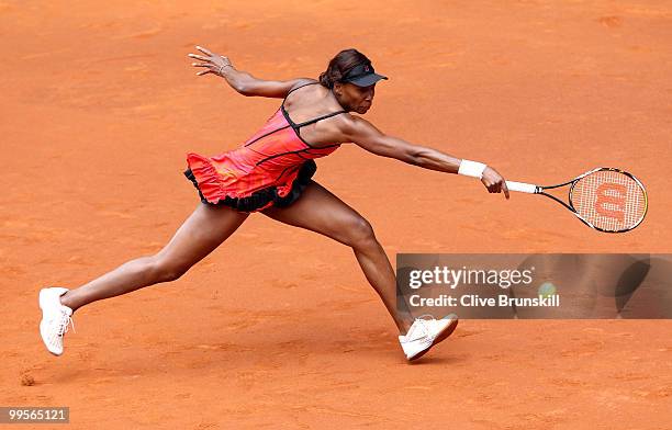 Venus Williams of the USA stretches to play a backhand against Shahar Peer of Israel in their semi final match during the Mutua Madrilena Madrid Open...