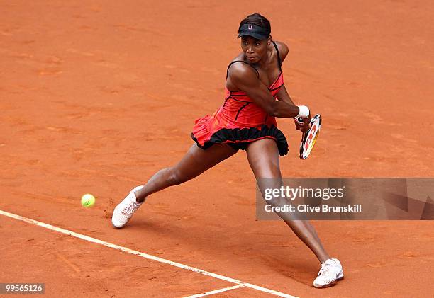 Venus Williams of the USA plays a backhand against Shahar Peer of Israel in their semi final match during the Mutua Madrilena Madrid Open tennis...