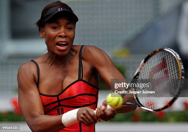 Venus Williams of the USA plays a backhand to Shahar Peer of Israel in their semi-final match during the Mutua Madrilena Madrid Open tennis...