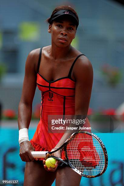Venus Williams of the USA concentrates on her serve in her semi-final match against Shahar Peer of Israel during the Mutua Madrilena Madrid Open...