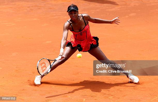 Venus Williams of the USA stretches to play a forehand against Shahar Peer of Israel in their semi final match during the Mutua Madrilena Madrid Open...