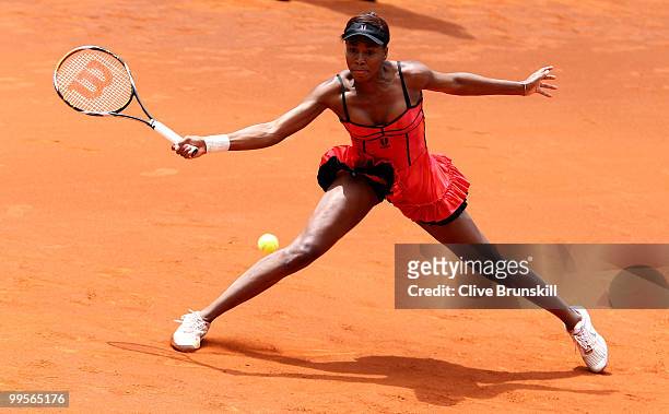Venus Williams of the USA stretches to play a forehand against Shahar Peer of Israel in their semi final match during the Mutua Madrilena Madrid Open...