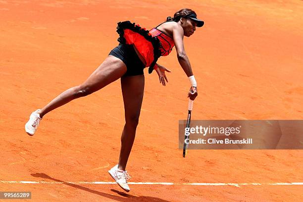 Venus Williams of the USA serves against Shahar Peer of Israel in their semi final match during the Mutua Madrilena Madrid Open tennis tournament at...