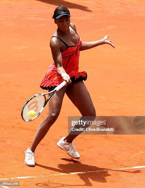 Venus Williams of the USA plays a forehand against Shahar Peer of Israel in their semi final match during the Mutua Madrilena Madrid Open tennis...